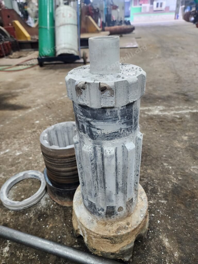 DTH hammer bit with clay and slurry packed around the splines