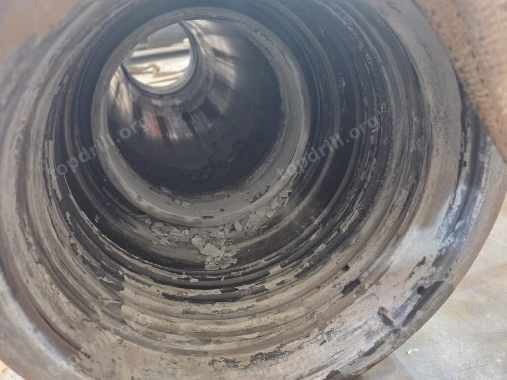 Sludge deposits inside a DTH hammer case after groundwater backflow