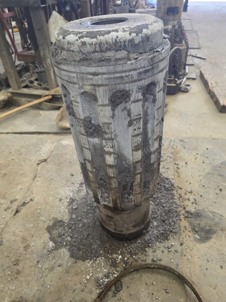 Silt sludge packed on a DTH hammer piston after backflow