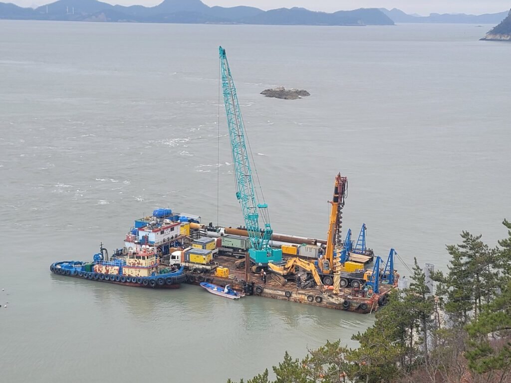 	Work barge with crawler crane and drilling rig at offshore observatory foundation site, Jindo Korea
