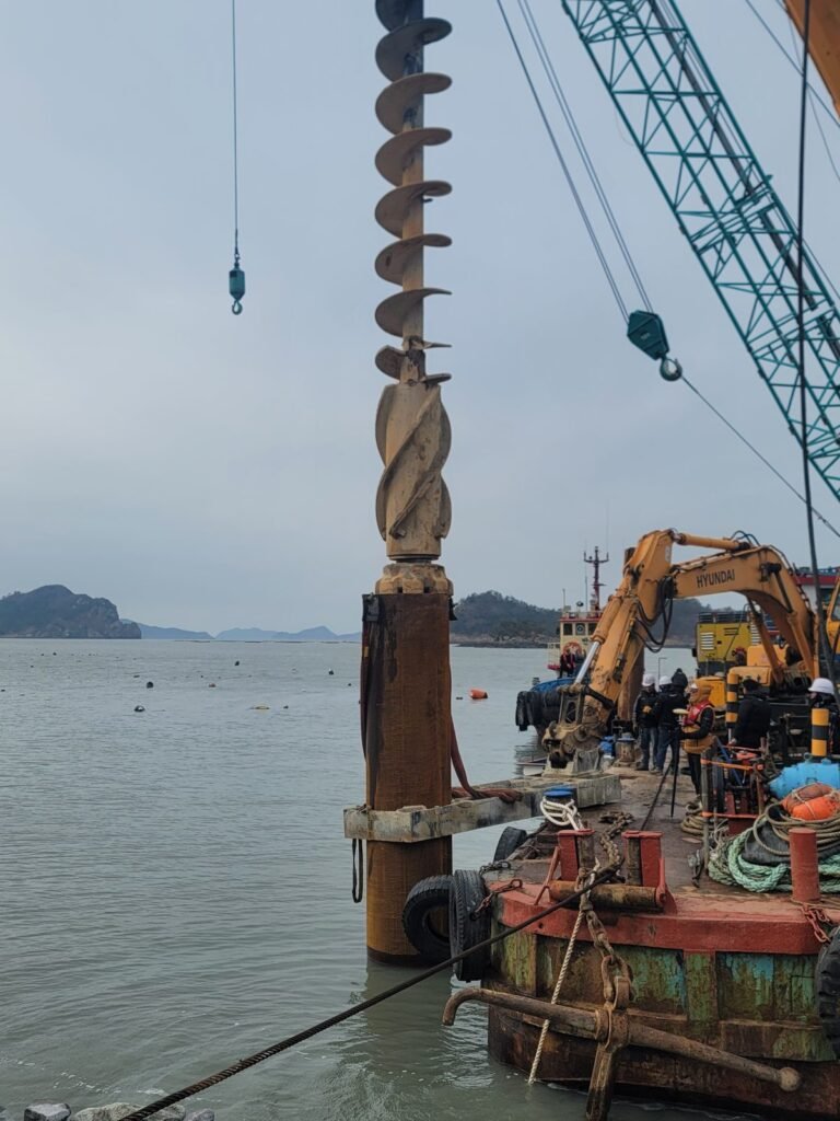 Air and cuttings discharging at casing head during submerged large diameter DTH drilling