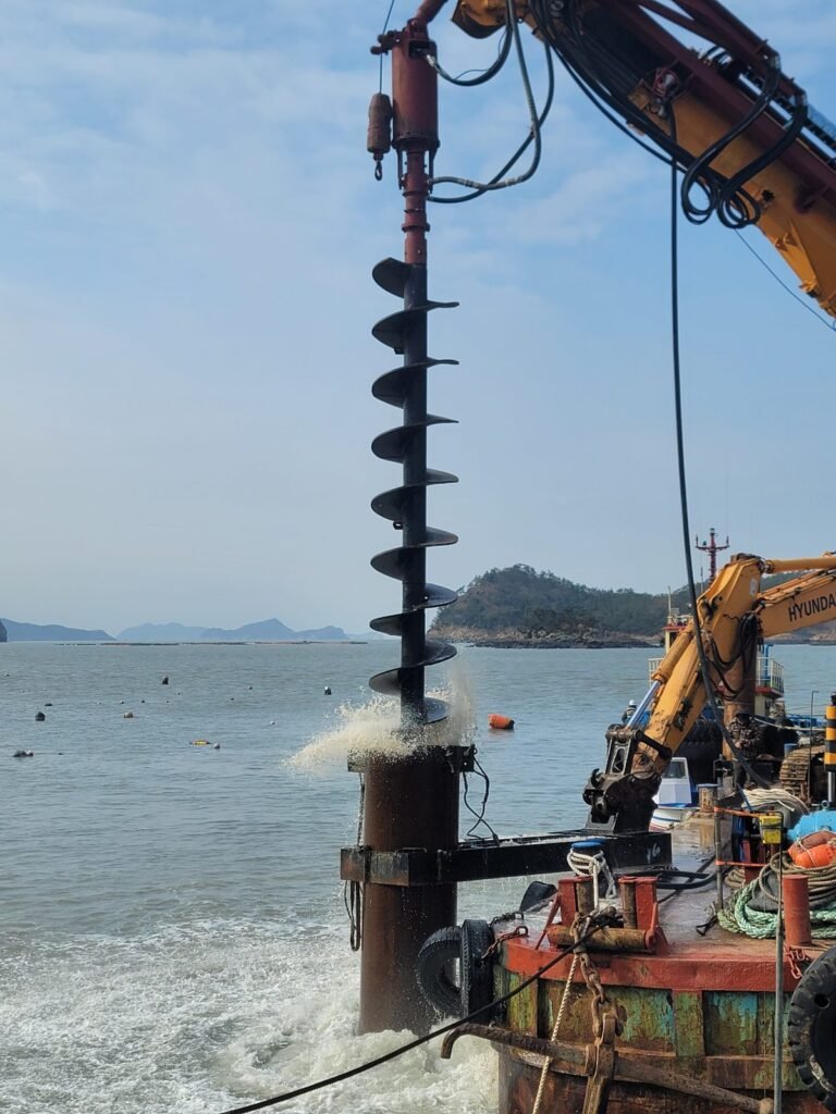 Air and cuttings discharging at casing head during submerged large diameter DTH drilling