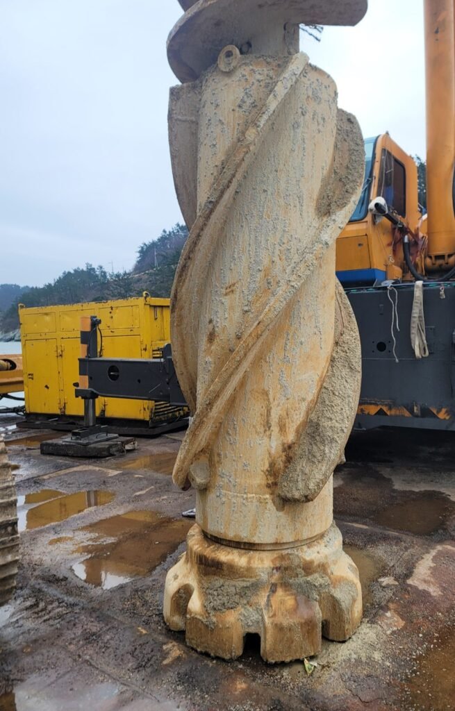 Large diameter DTH hammer with 1030mm bit packed with weathered soil after extraction