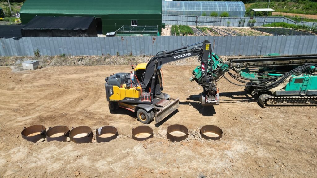 Excavator placing steel moulds for the UHPC hard-rock test cylinders