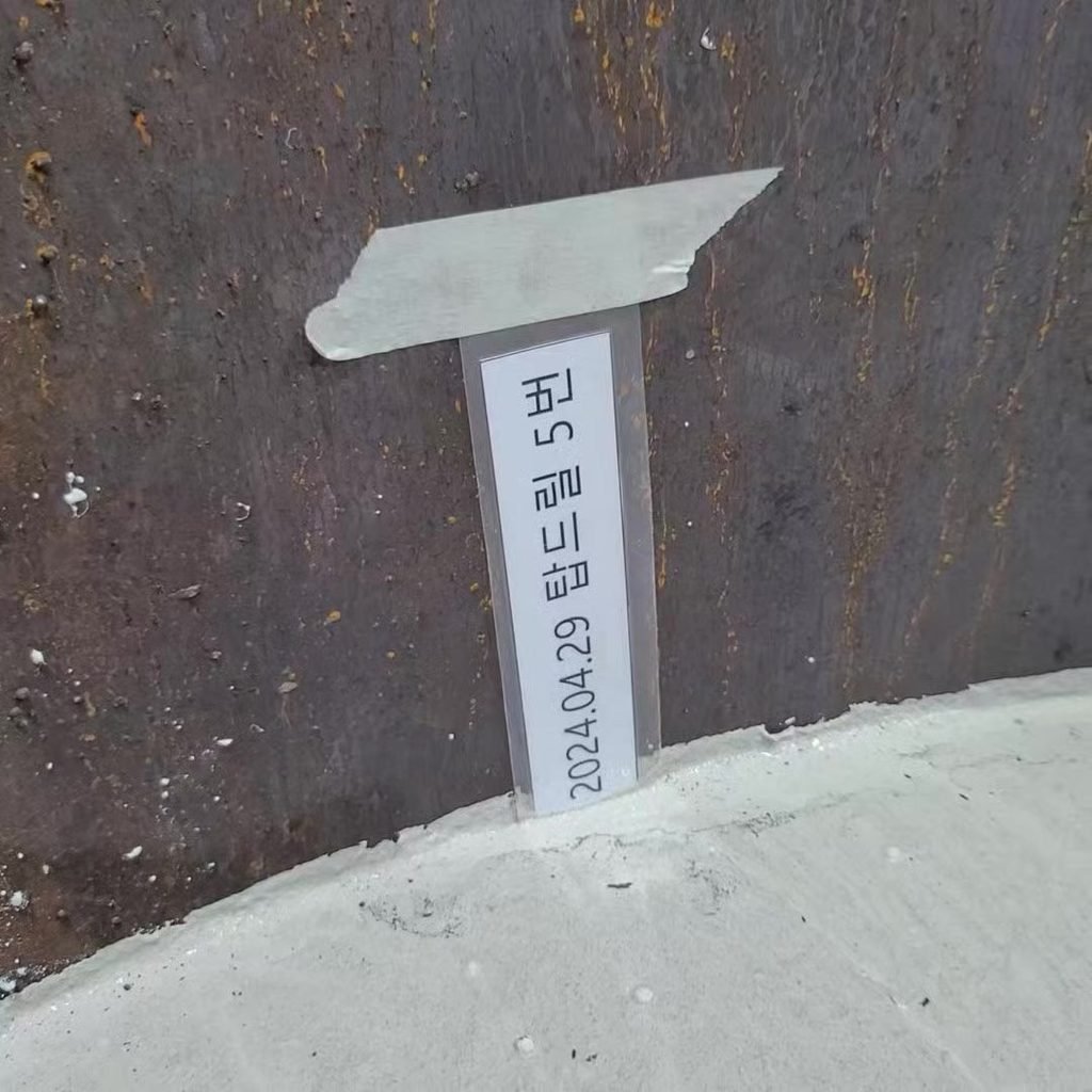 UHPC surface right after casting, test-cylinder label “TOPDRILL No. 5”