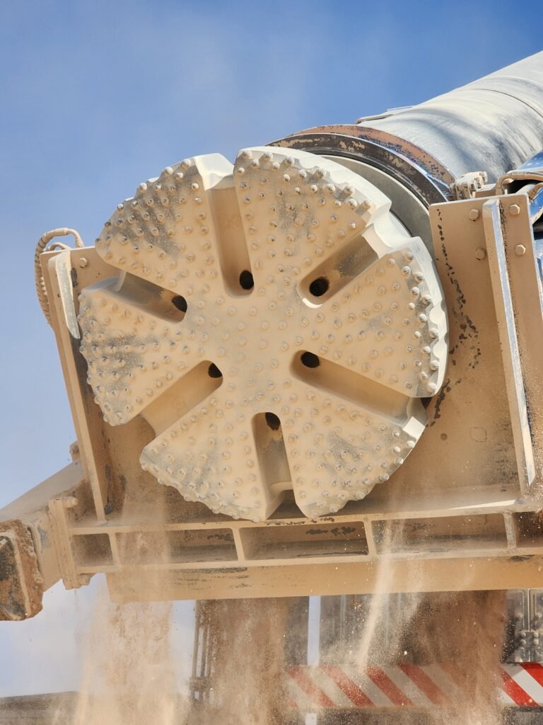 Ø1,000 mm large diameter DTH bit face, dust-covered after drilling hard abrasive gabbro