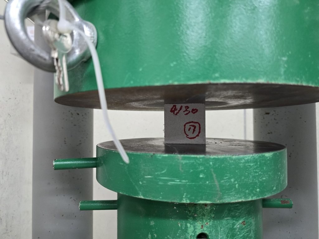 50 mm UHPC specimen in the compressive-strength testing machine